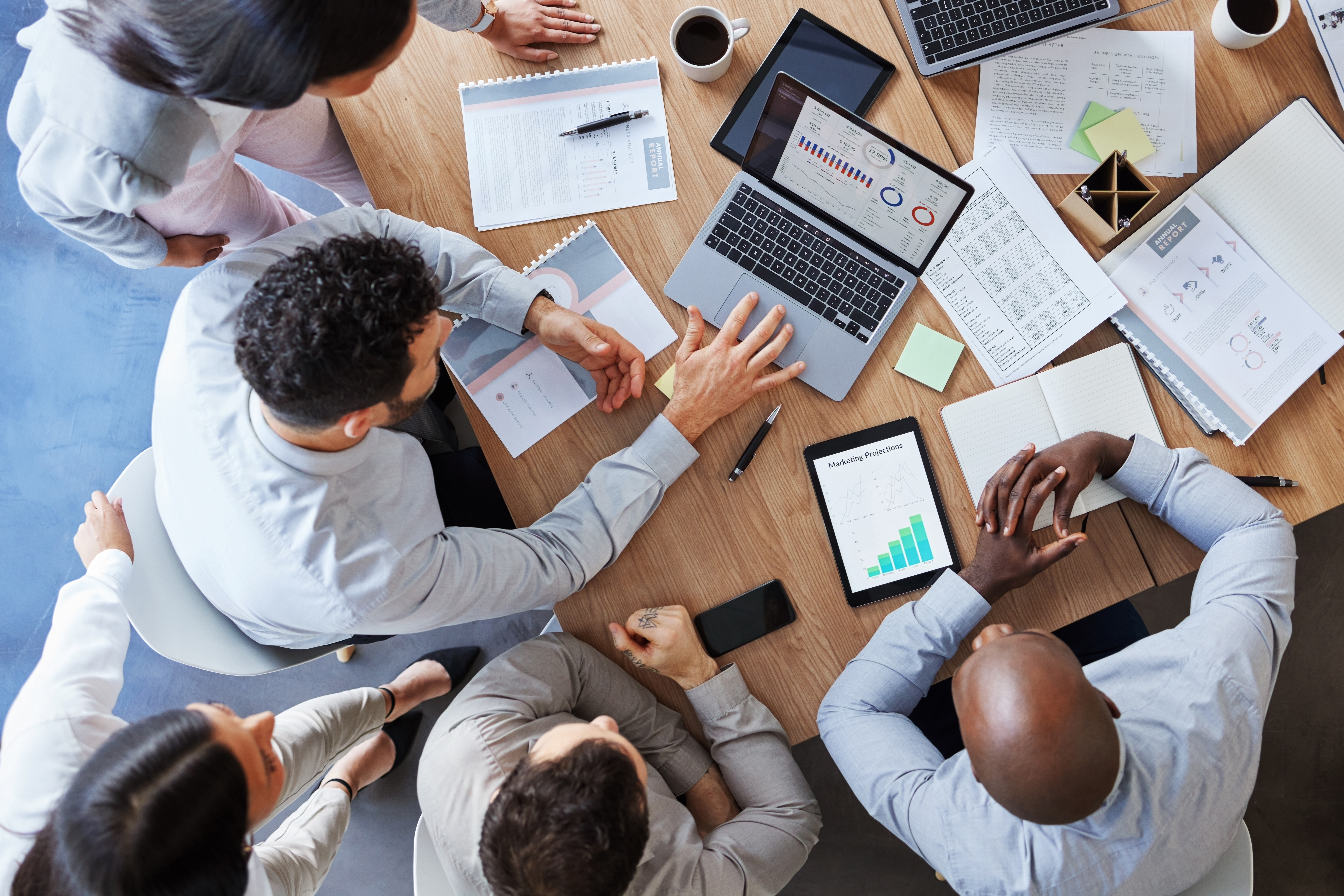 Shot of a group of unrecognizable businesspeople working together to meet their deadline at work